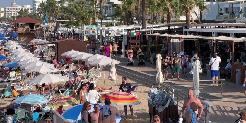 Beachgoers at Cyprus' southeastern touristic resort of Protaras ...